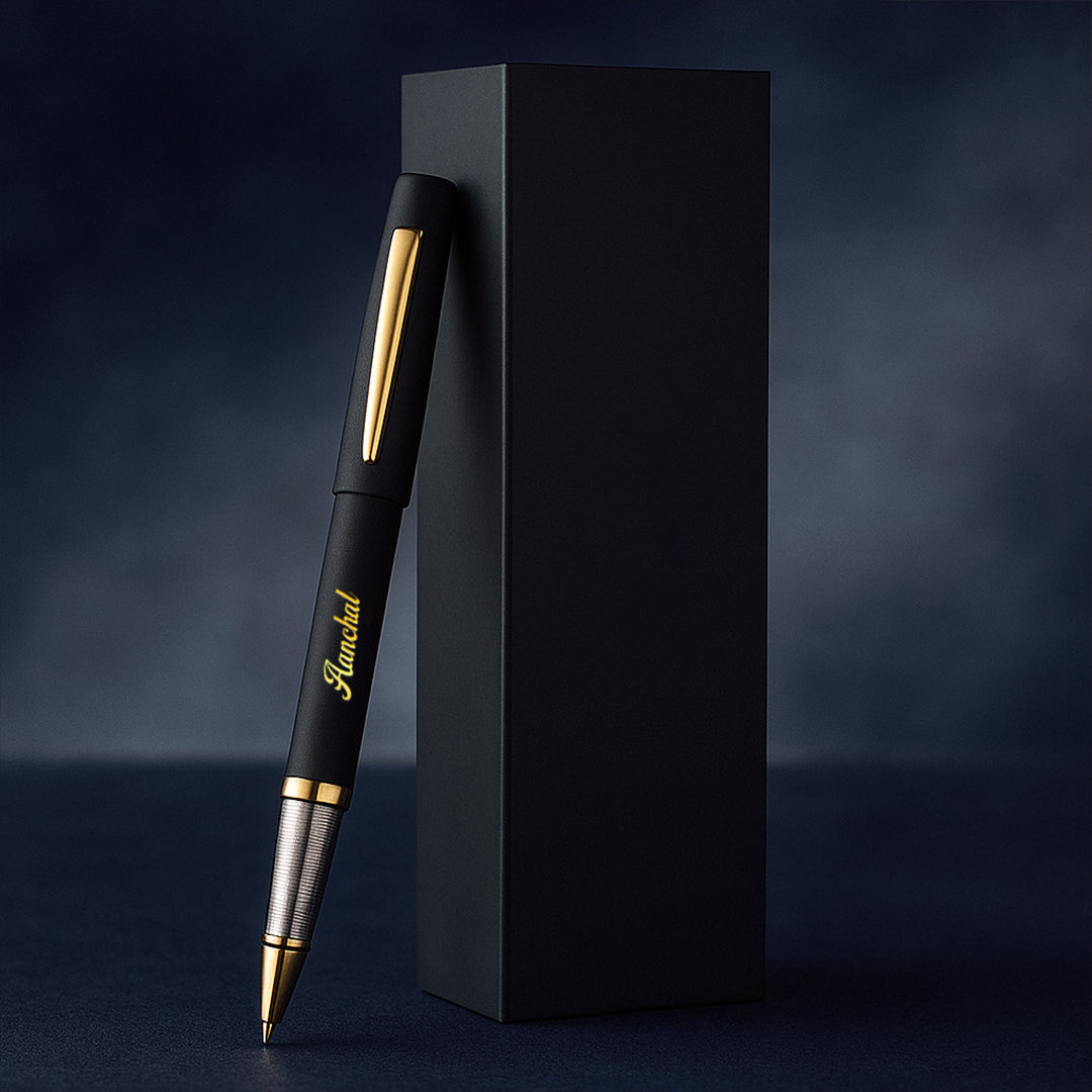 Black pen with gold accents next to a black box on a dark background