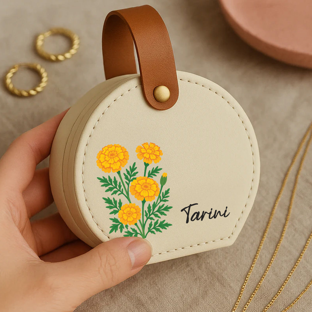 A compact white travel jewellery box with a floral design, featuring a brown leather handle. best for women gifting
