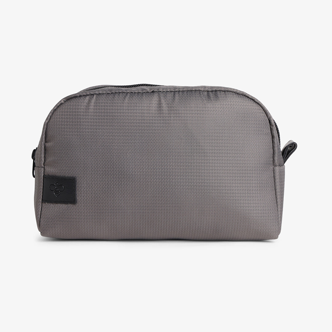 A gray premium travel pouch with a zipper closure and a brand tag on the front.